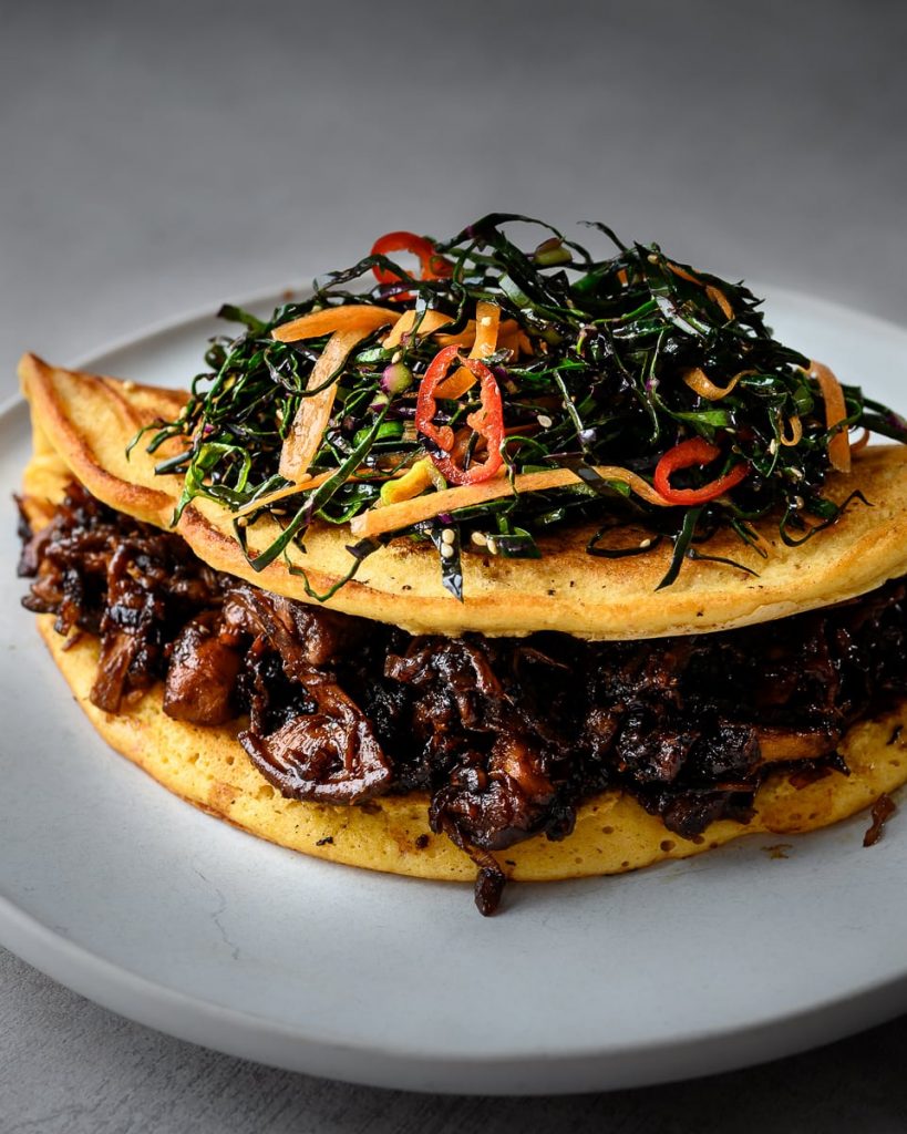 vegan kimchi pancake with tamari mushrooms and slaw
