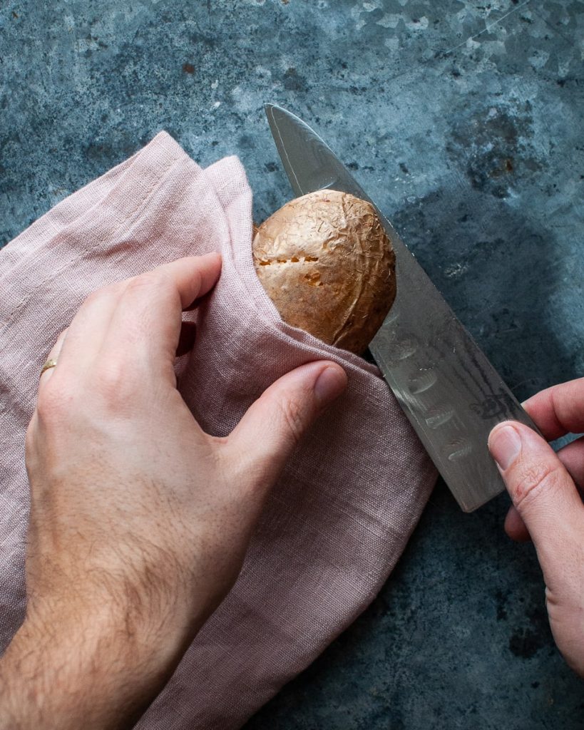 slicing a baked potato