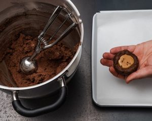 filling the cookie dough with peanut butter