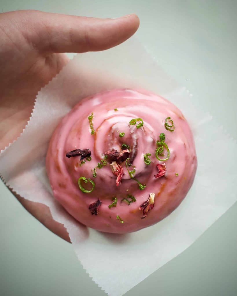 vegan cinnamon swirls with hibiscus and lime glaze