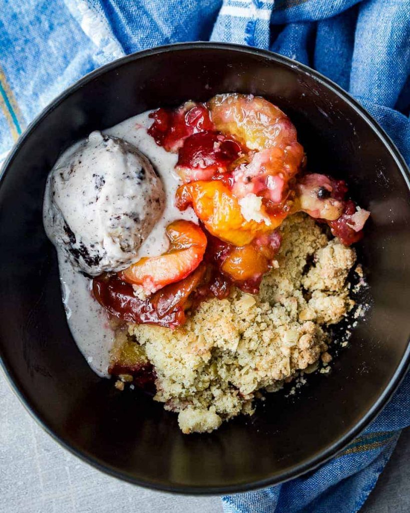 vegan crumble with damson plums and ice cream