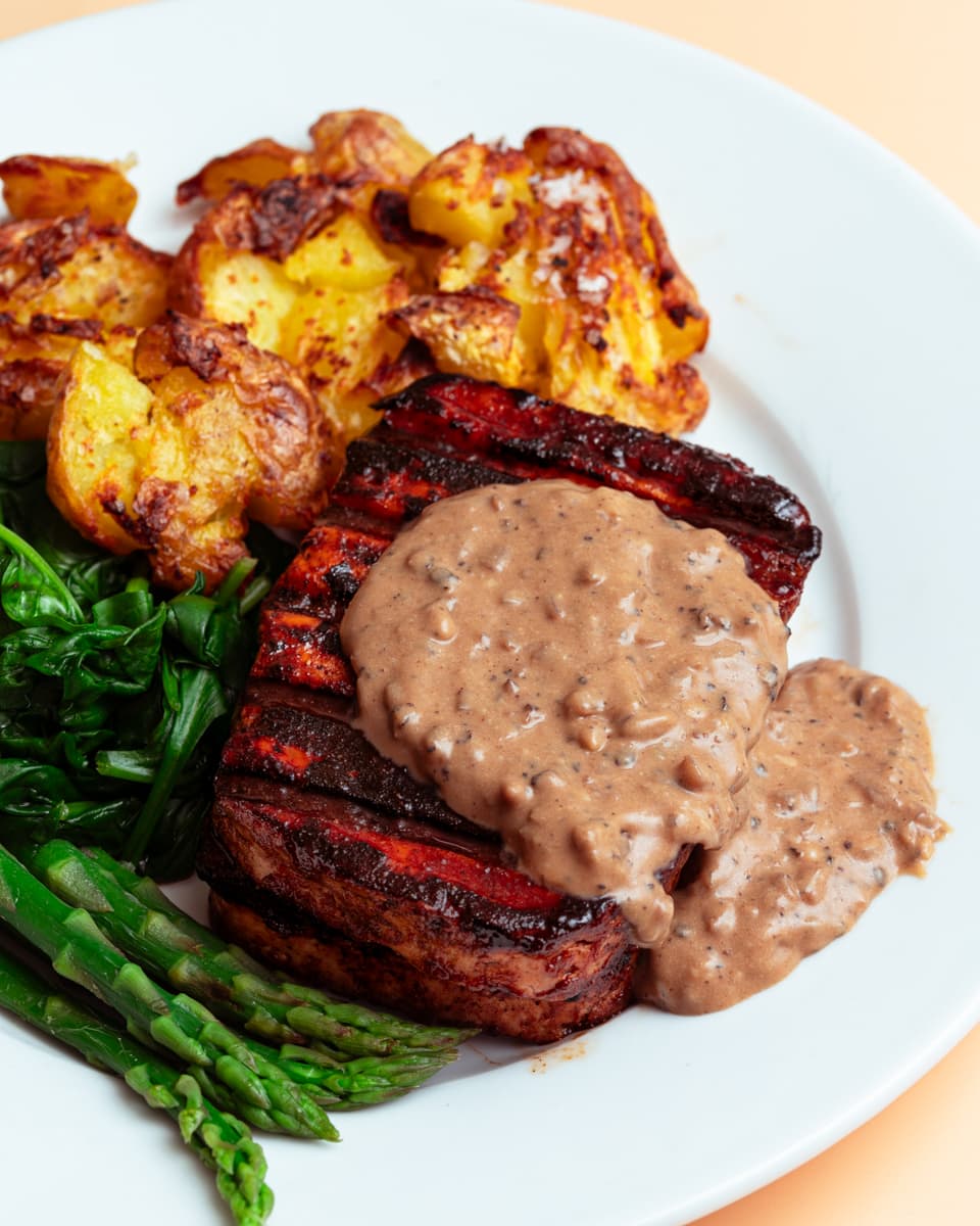 tofu steak with vegan peppercorn sauce and smashed potatoes