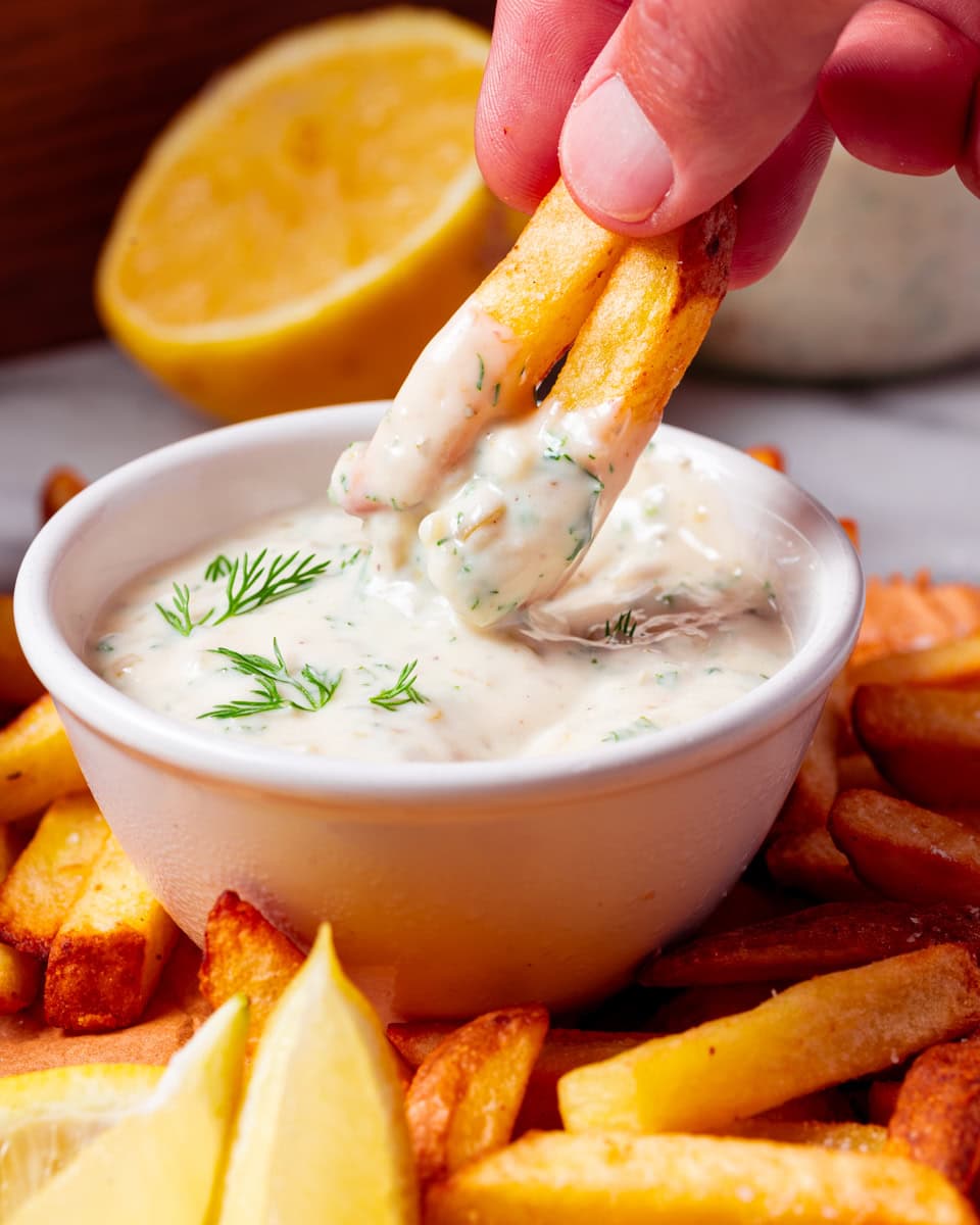 dipping chips into vegan tratare sauce