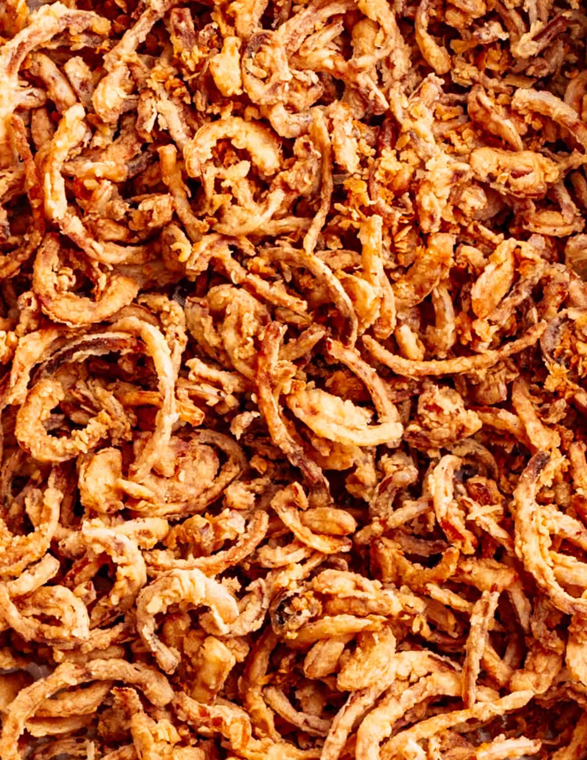 A close-up photograph of golden brown crispy french fried onions