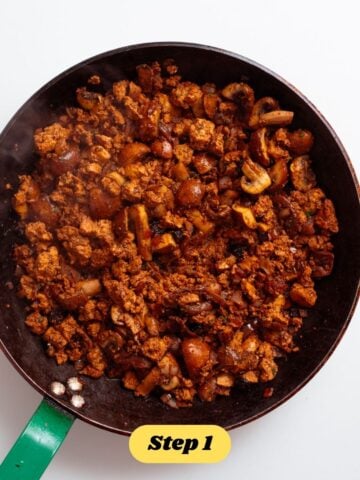 The filling for the vegan sausage rolls being prepared in a frying pan. 