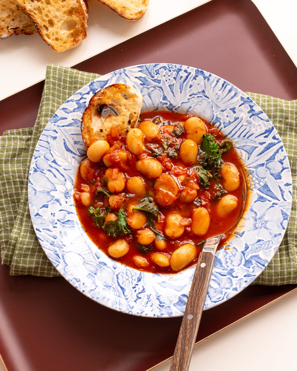 A tray with a bowl of vegan butter bean stew