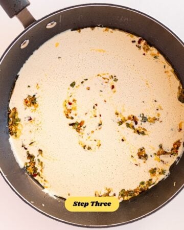 A frying pan with the creamy sauce